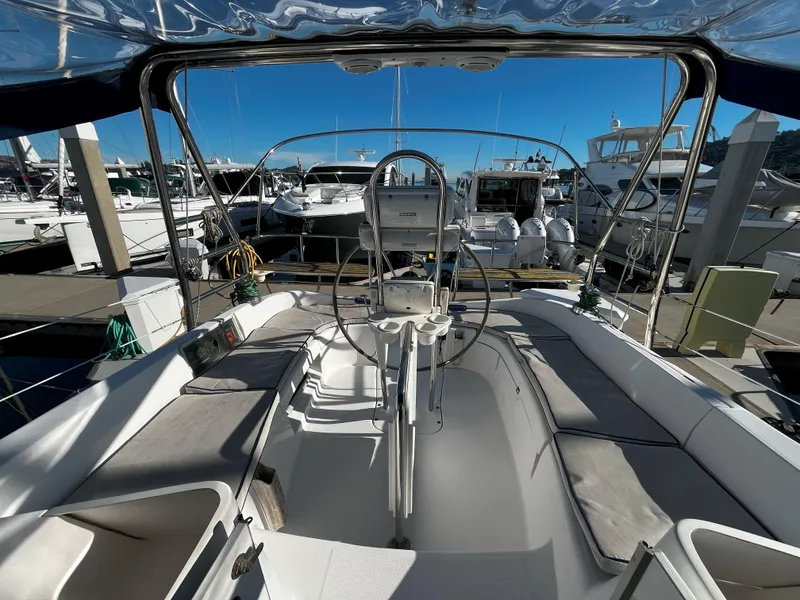 Slide: The Image of 2005 Hunter 41 sailboat cockpit with steering wheel, docked at marina. - 19
