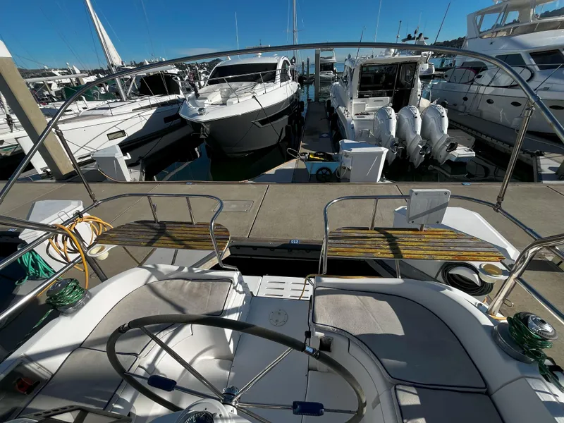Slide: The Image of Hunter 41 sailboat cockpit view, docked at marina, surrounded by other boats, 2005 model. - 20