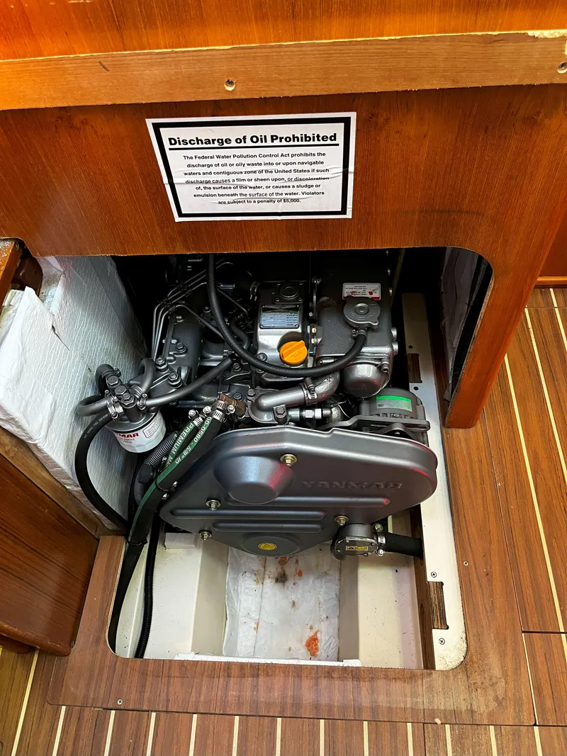 Slide: The Image of Engine compartment of 2005 Hunter 41 sailboat with oil discharge warning sign. - 21