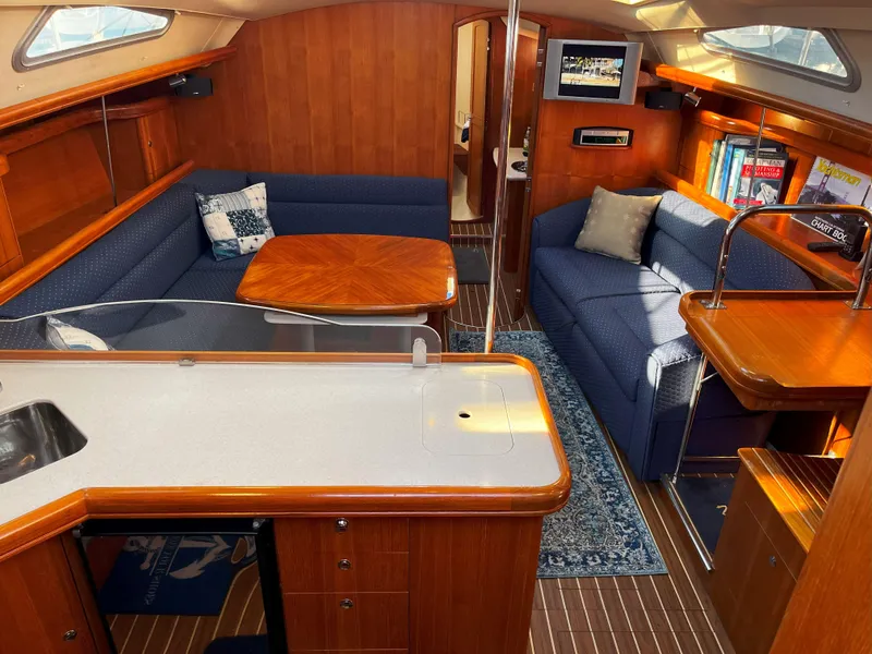 Slide: The Image of Interior of 2005 Hunter 41 sailboat with cozy seating and wooden finishes. - 23