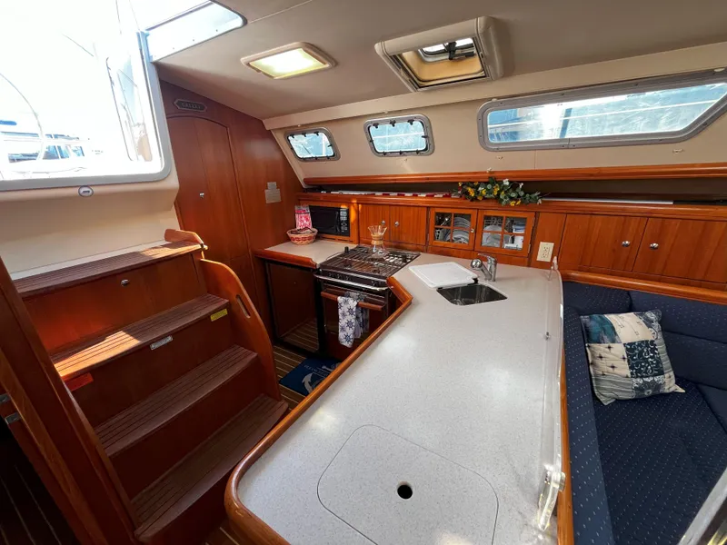 Slide: The Image of Interior of 2005 Hunter 41 sailboat with modern kitchen and seating area. - 24