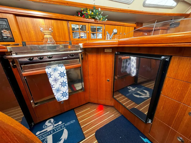 Slide: The Image of Luxurious 2005 Hunter 41 yacht kitchen with wood cabinetry and modern appliances. - 27