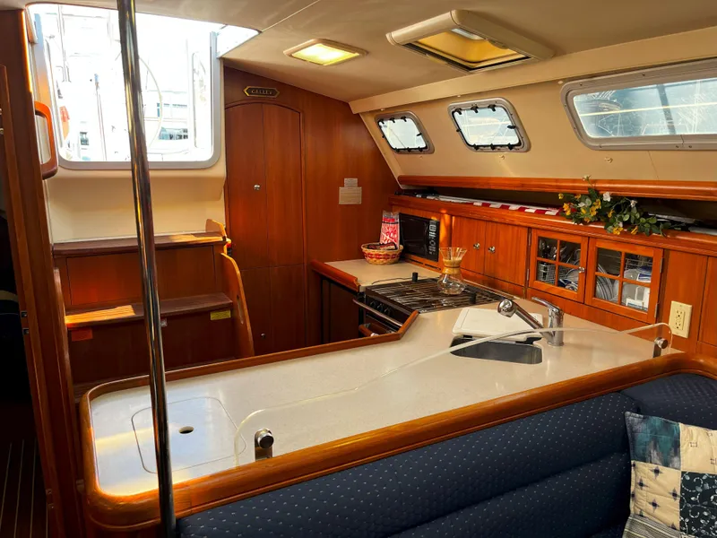 Slide: The Image of Interior of 2005 Hunter 41 sailboat kitchen with wood cabinetry and modern appliances. - 29