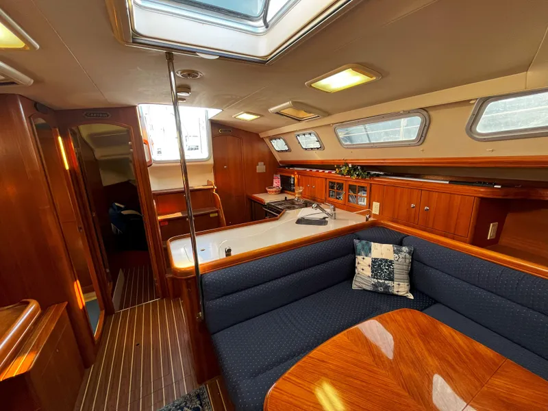 Slide: The Image of Interior of 2005 Hunter 41 sailboat with wood finish and cozy seating area. - 30