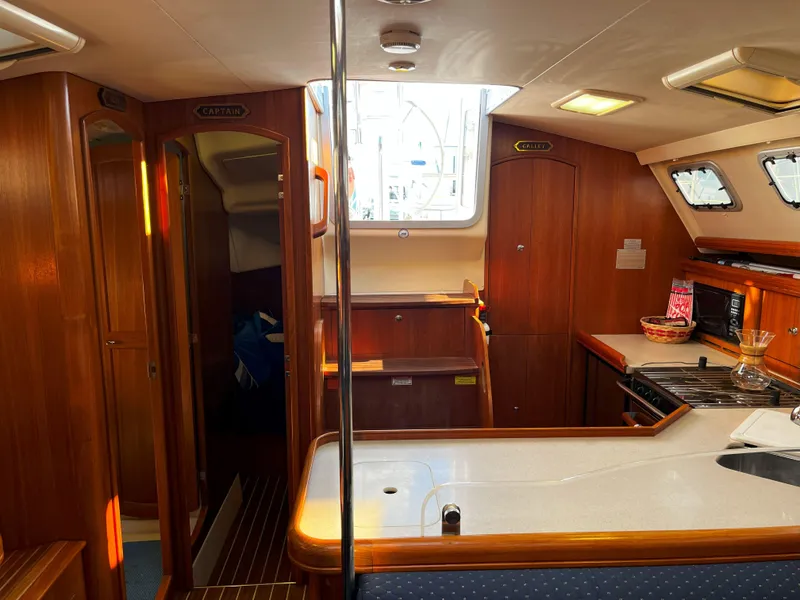 Slide: The Image of Interior of 2005 Hunter 41 sailboat with wood finish and modern kitchen amenities. - 31