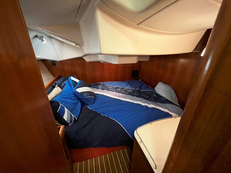 Slide: The Image of Cozy cabin interior of 2005 Hunter 41 sailboat with blue bedding. - 34