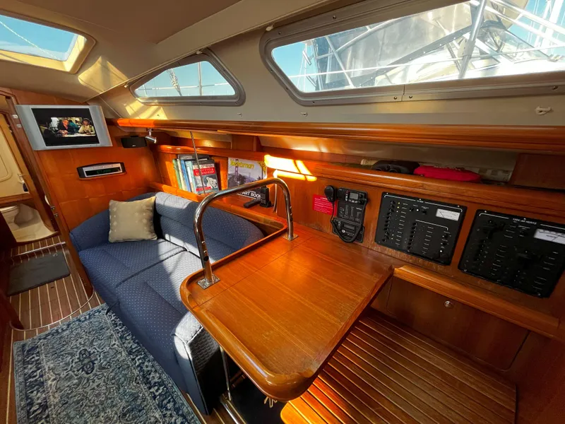 Slide: The Image of Interior of 2005 Hunter 41 sailboat with cozy seating and navigation equipment. - 37