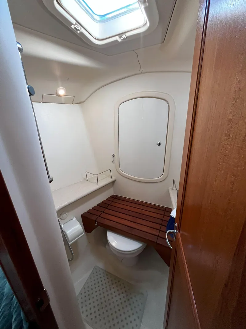 Slide: The Image of 2005 Hunter 41 yacht bathroom with skylight and wooden bench. - 45