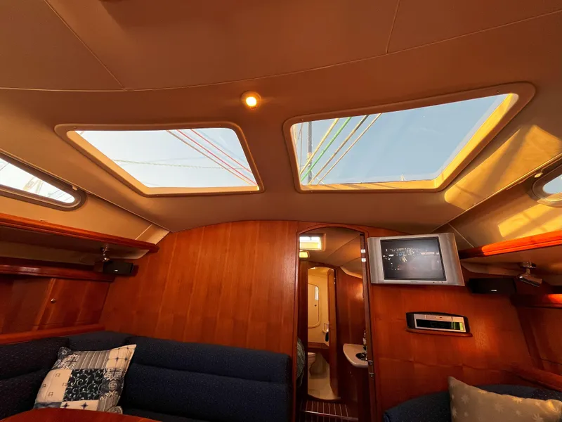 Slide: The Image of Interior of 2005 Hunter 41 sailboat with skylights and cozy seating area. - 48