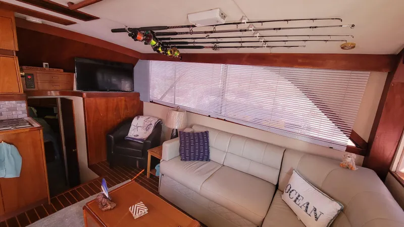 Slide: The Image of Interior of 1988 Ocean Yachts 38 Super Sports with cozy seating and fishing rods. - 11