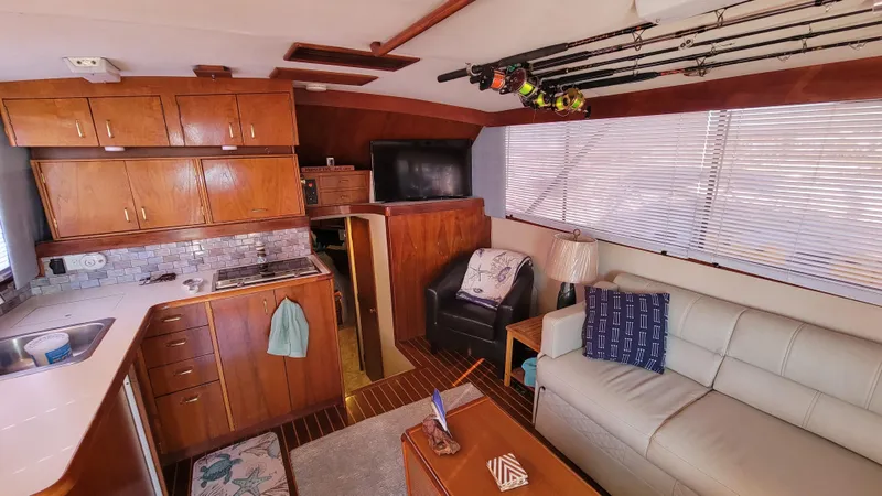 Slide: The Image of Interior of 1988 Ocean Yachts 38 Super Sports with cozy seating and fishing rods. - 12