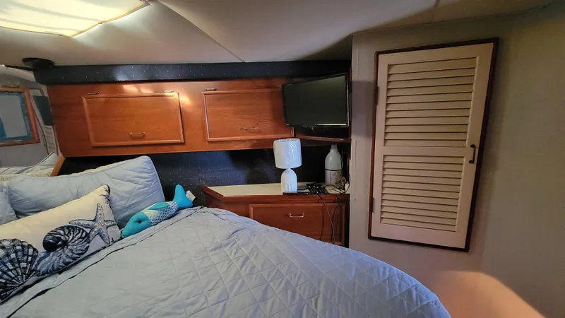 Slide: The Image of Cozy bedroom in 1988 Ocean Yachts 38 Super Sports with wooden cabinets and soft bedding. - 17