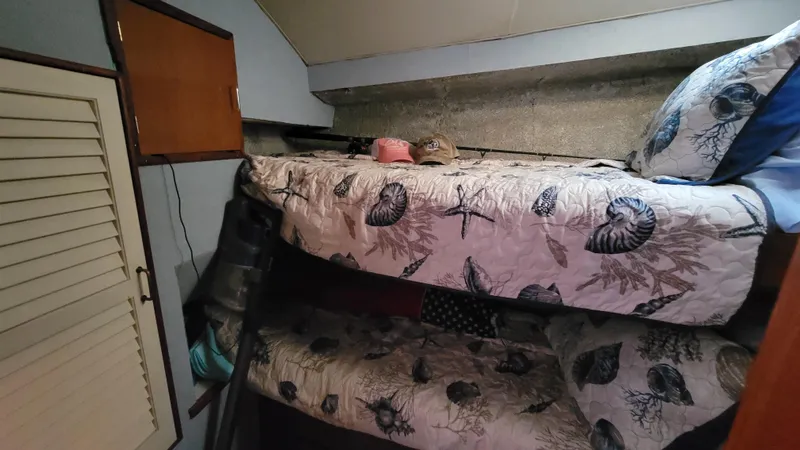 Slide: The Image of Bunk beds in 1988 Ocean Yachts 38 Super Sports cabin with seashell-themed bedding. - 20
