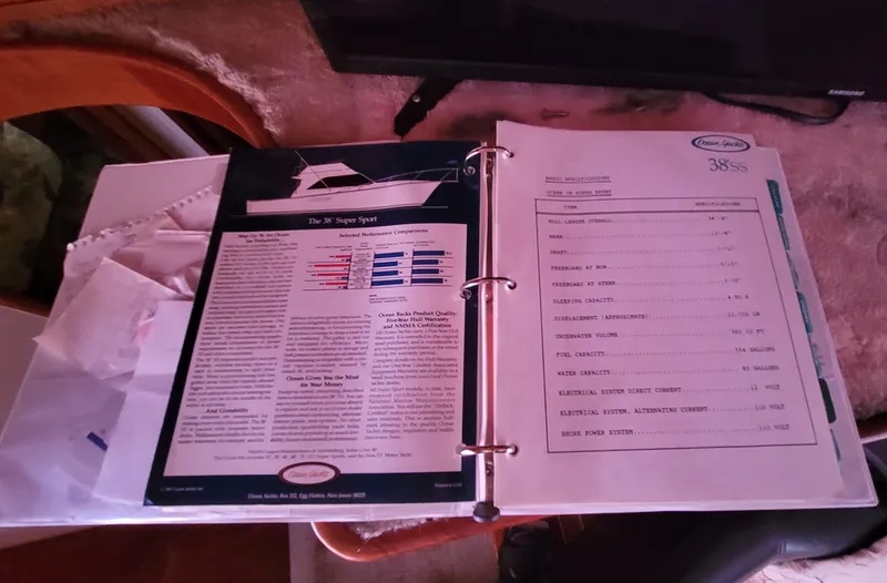 Slide: The Image of Open manual of 1988 Ocean Yachts 38 Super Sports on a table. - 22