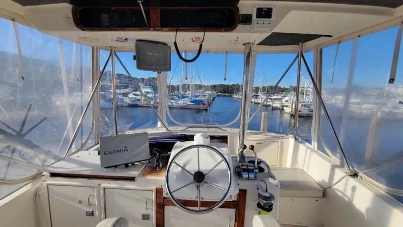 Slide: The Image of Interior view of 1988 Ocean Yachts 38 Super Sports boat cockpit with marina background. - 29