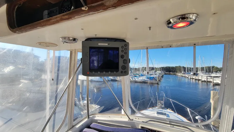 Slide: The Image of Interior view of 1988 Ocean Yachts 38 Super Sports with marina background. - 31