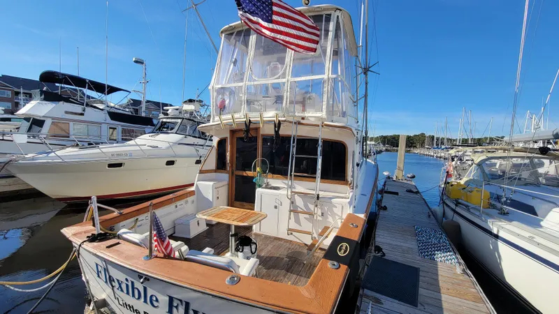 Slide: The Image of 1988 Ocean Yachts 38 Super Sports docked at marina, American flag displayed. - 4