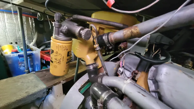 Slide: The Image of Engine room of 1988 Ocean Yachts 38 Super Sports, showcasing mechanical components and filters. - 40