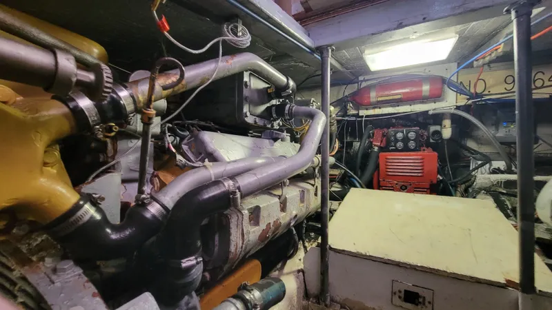 Slide: The Image of Engine room of 1988 Ocean Yachts 38 Super Sports, showcasing mechanical components. - 42