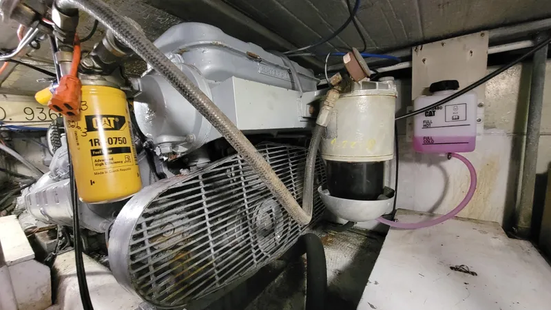 Slide: The Image of Engine room of 1988 Ocean Yachts 38 Super Sports, featuring mechanical components and filters. - 43