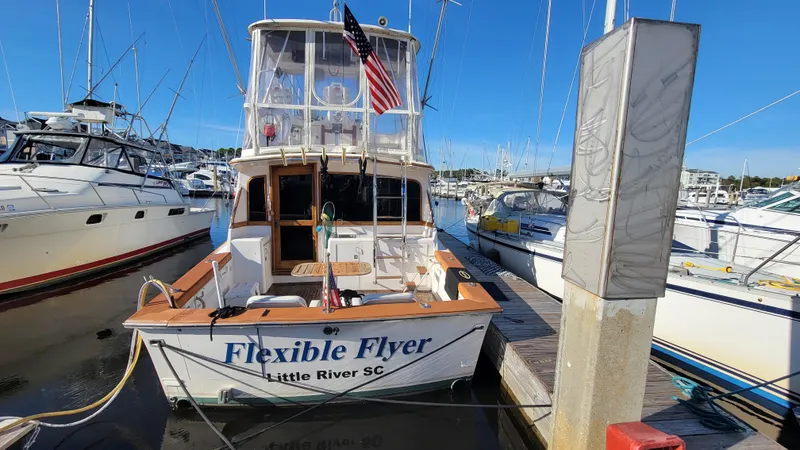 Slide: The Image of 1988 Ocean Yachts 38 Super Sports docked, named "Flexible Flyer," in Little River, SC marina. - 5