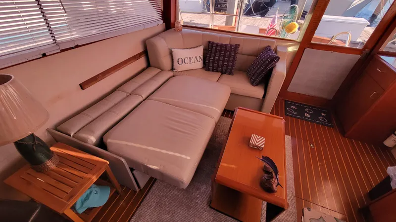 Slide: The Image of Cozy interior of 1988 Ocean Yachts 38 Super Sports with sofa and wooden accents. - 7