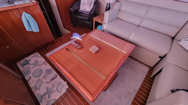 Slide: The Image of Interior of 1988 Ocean Yachts 38 Super Sports with wooden table and seating area. - 8
