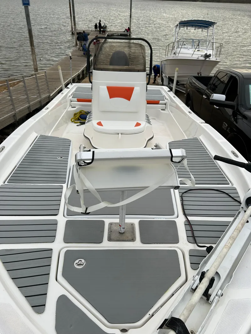 Slide: The Image of 2013 Epic 22 SC boat docked by the water, featuring a sleek deck design. - 10