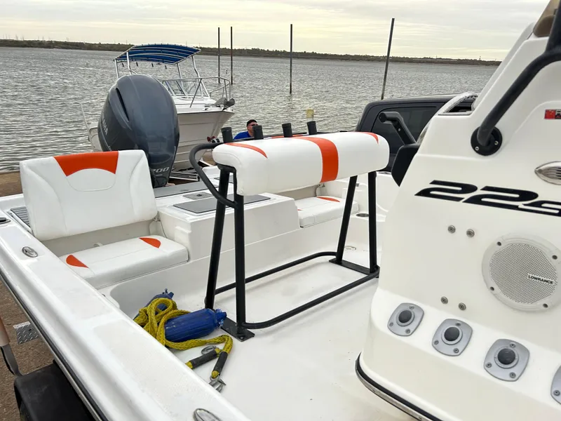 Slide: The Image of 2013 Epic 22 SC boat interior with seating and control panel by the water. - 13