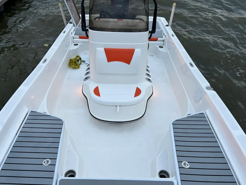 Slide: The Image of 2013 Epic 22 SC boat interior with orange accents and sleek design on the water. - 17