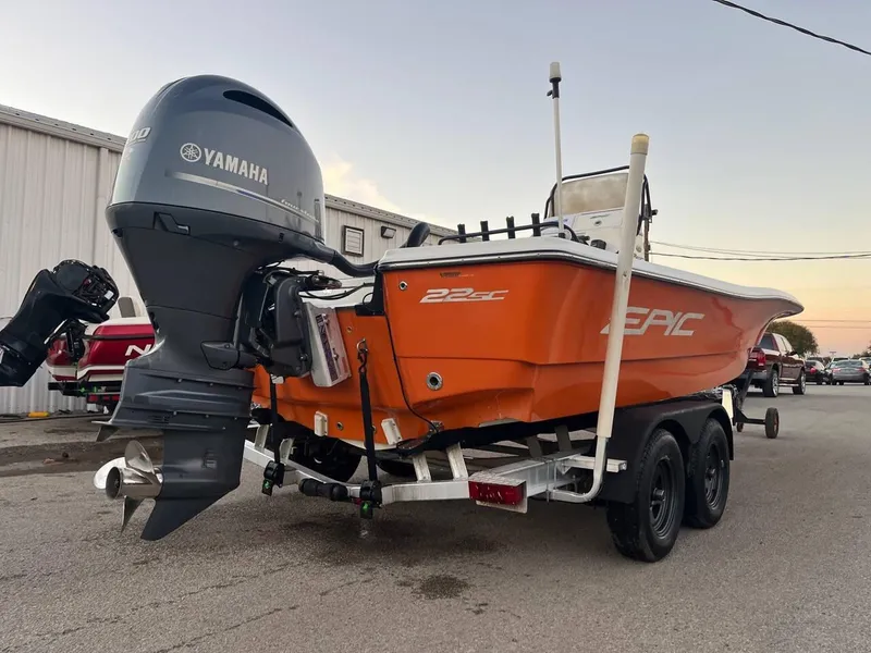 Slide: The Image of Orange 2013 Epic 22 SC boat with Yamaha outboard motor on trailer. - 22