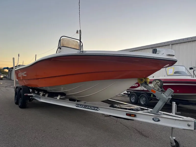 Slide: The Image of 2013 Epic 22 SC boat on trailer at sunset, side view. - 23