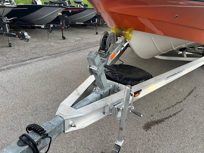 Slide: The Image of 2013 Epic 22 SC boat on trailer, parked on asphalt lot. - 24