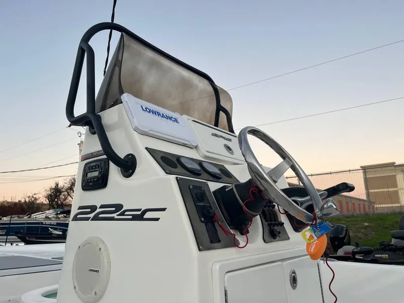 Slide: The Image of Epic 22 SC 2013 boat console with steering wheel and Lowrance equipment. - 31