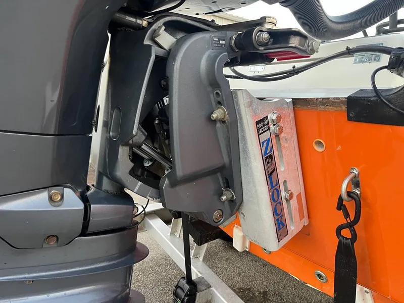 Slide: The Image of Close-up of 2013 Epic 22 SC boat motor and mounting bracket. - 32