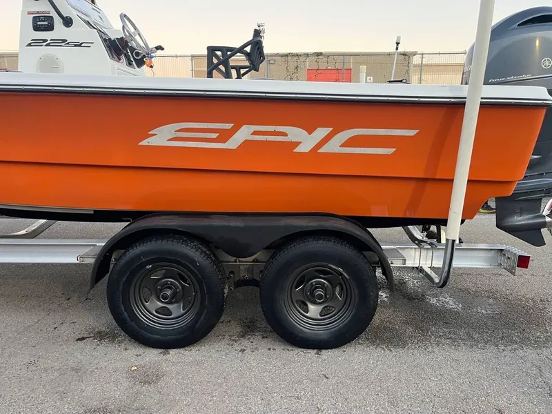 Slide: The Image of 2013 Epic 22 SC boat on trailer, vibrant orange hull, dual wheels. - 35