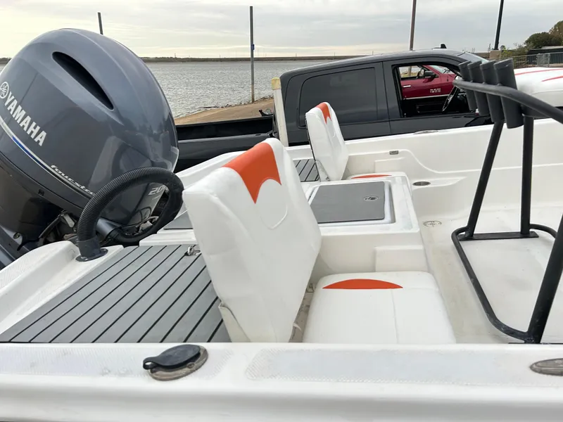 Slide: The Image of 2013 Epic 22 SC boat with Yamaha engine, docked near a waterfront. - 39