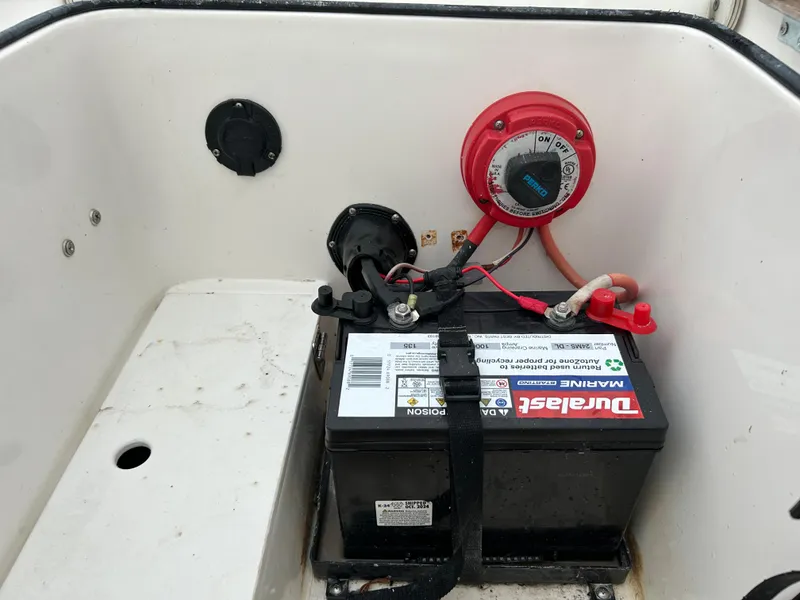 Slide: The Image of Boat battery compartment with Duralast marine battery and power switch, Epic 22 SC, 2013 model. - 45