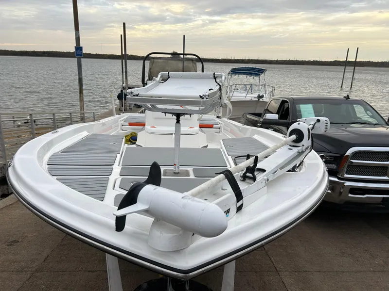 Slide: The Image of 2013 Epic 22 SC boat docked by the water, featuring a sleek design and modern equipment. - 5