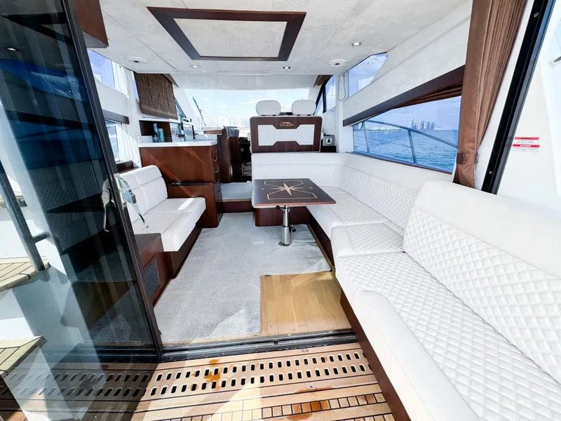 Slide: The Image of Luxurious interior of 2016 Galeon 420 Fly yacht with white seating and wooden accents. - 11