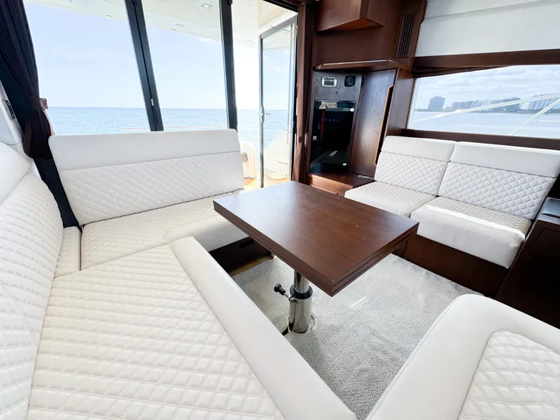 Slide: The Image of Luxurious interior of 2016 Galeon 420 Fly yacht with white seating and wooden table. - 17