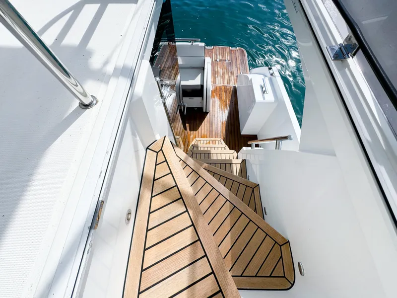 Slide: The Image of Staircase on 2016 Galeon 420 Fly yacht leading to wooden deck by the water. - 21