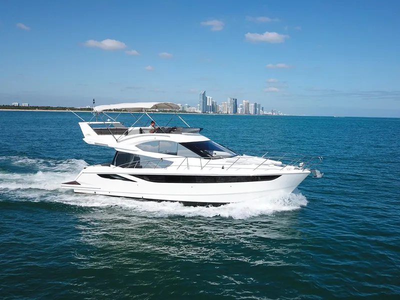 Slide: The Image of Galeon 420 Fly 2016 yacht cruising on blue ocean near city skyline. - 40