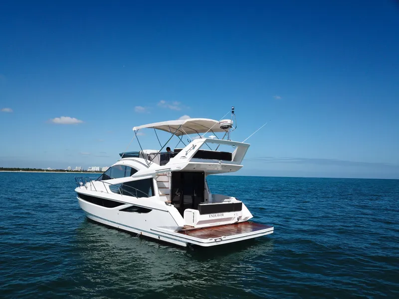 Slide: The Image of 2016 Galeon 420 Fly yacht cruising on open water under clear blue skies. - 43