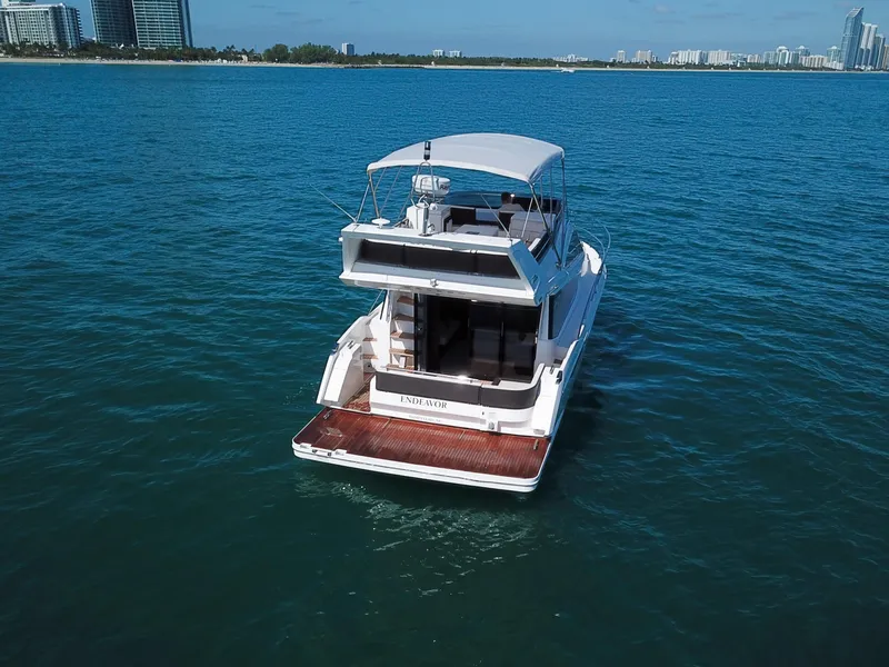 Slide: The Image of 2016 Galeon 420 Fly yacht on open water, city skyline in background. - 45