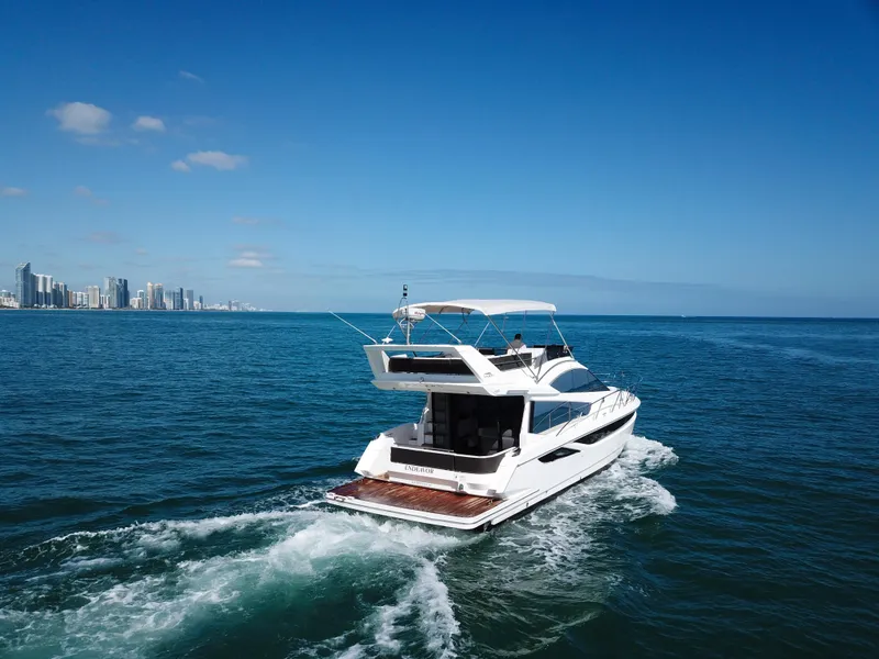 Slide: The Image of 2016 Galeon 420 Fly yacht cruising on open sea near city skyline. - 46