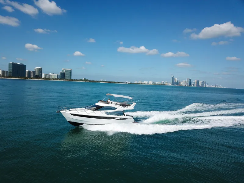 Slide: The Image of Galeon 420 Fly 2016 yacht cruising on blue ocean near city skyline. - 7