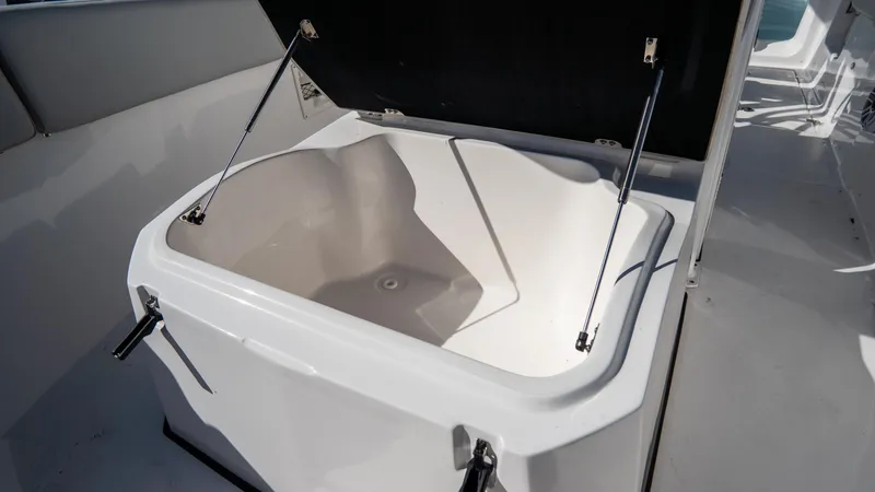 Slide: The Image of 2024 Sea Fox 268 Commander storage compartment with open lid. - 16