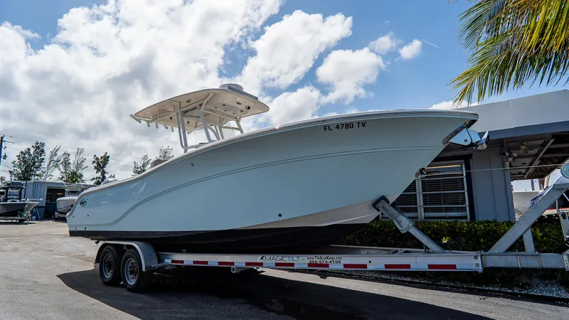 Slide: The Image of 2024 Sea Fox 268 Commander boat on trailer under blue sky. - 2