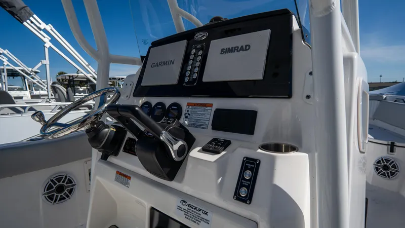 Slide: The Image of 2024 Sea Fox 268 Commander boat dashboard with Garmin and Simrad displays. - 26